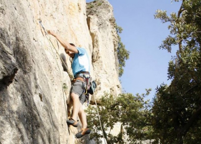  young man practicing climbing 